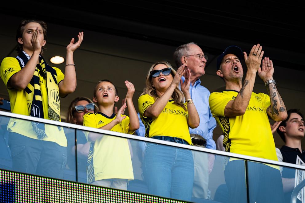 PHOTO: Reese Witherspoon with her sons Deacon Phillippe, Tennessee Toth and her husband Jim Toth, cheers on the Nashville Soccer Club during the Inaugural home opener game between Philadelphia Union and Nashville SC, May 1, 2022, in Nashville, Tenn.