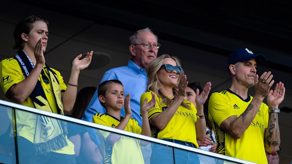 PHOTO: In this May 1, 2022, file photo, Reese Witherspoon, with her sons Deacon Phillippe, Tennessee Toth and her husband Jim Toth, cheers on the Nashville Soccer Club at GEODIS Park in Nashville, Tenn.