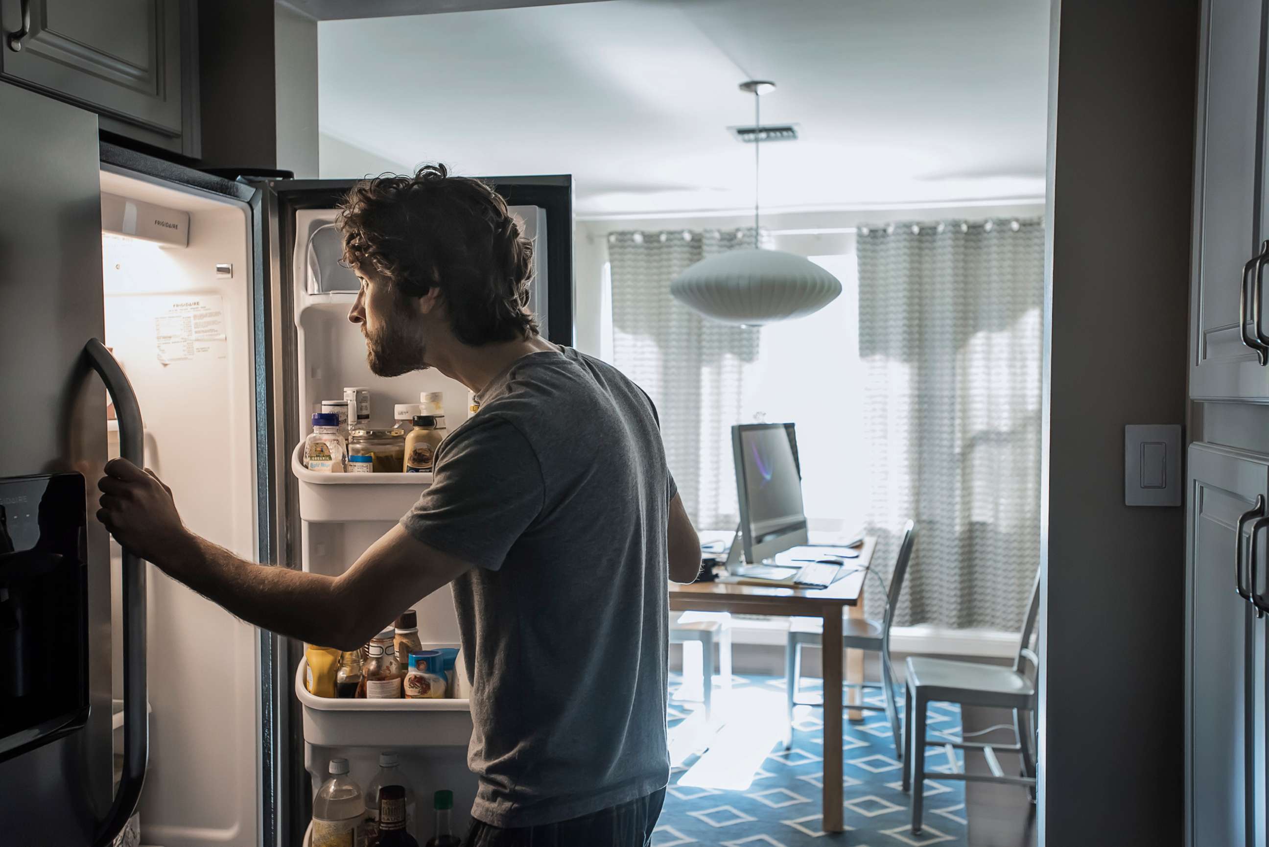 PHOTO: A man looks into a refrigerator in an undated stock photo.