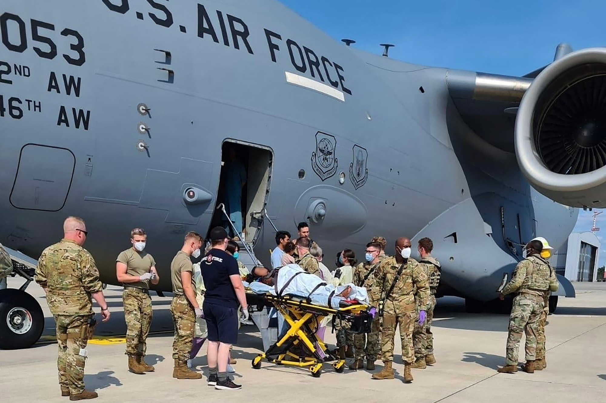 PHOTO: Medical support personnel from the 86th Medical Group help an Afghan mother and family off a U.S. Air Force C-17, after she delivered a child aboard the aircraft upon landing at Ramstein Air Base, Germany, Aug. 21, 2021. 