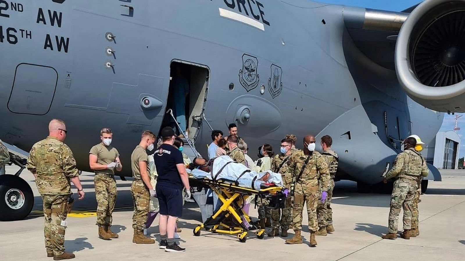 PHOTO: Medical support personnel from the 86th Medical Group help an Afghan mother and family off a U.S. Air Force C-17, after she delivered a child aboard the aircraft upon landing at Ramstein Air Base, Germany, Aug. 21, 2021.