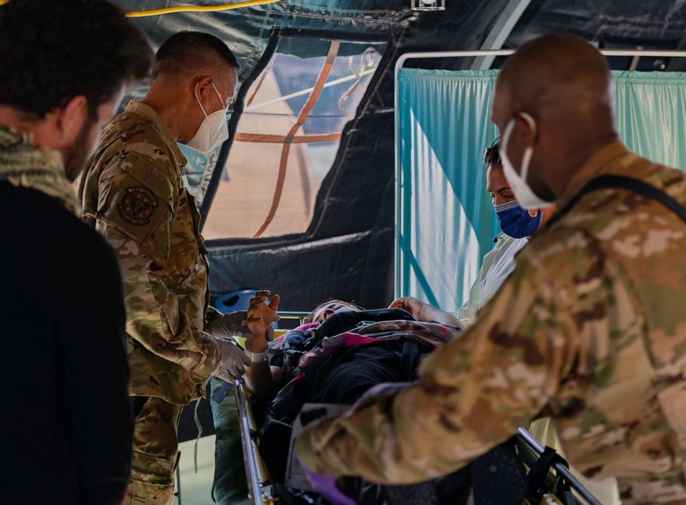 PHOTO: Airmen assigned to the 86th Medical Group provide post labor care to an Afghan mother who gave birth aboard a U.S. Air Force C-17 Globemaster III upon landing at Ramstein Air Base, Germany, Aug. 21, 2021.
