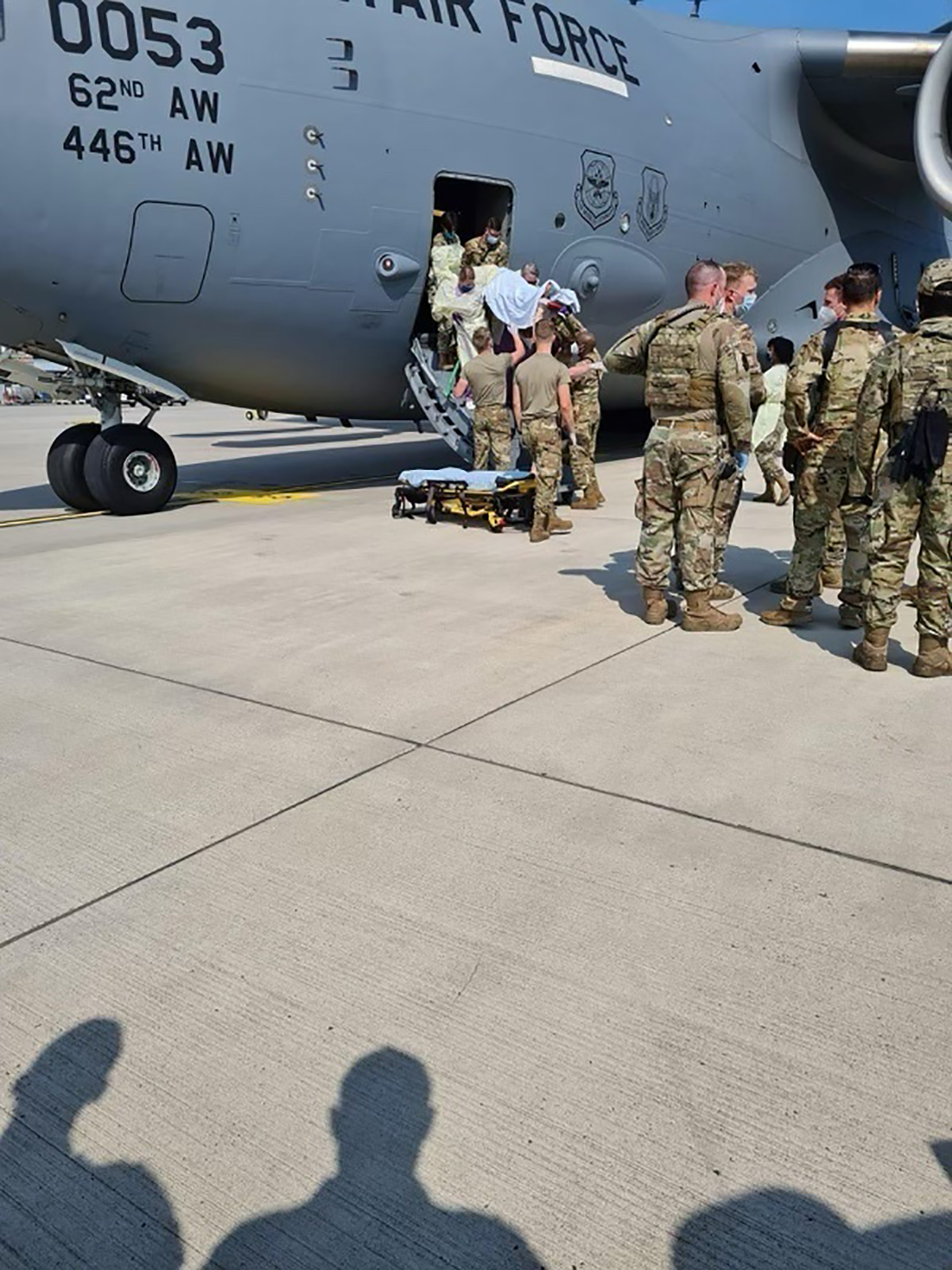 PHOTO: Medical support personnel from the 86th Medical Group help an Afghan mother and family off a U.S. Air Force C-17, after she delivered a child aboard the aircraft upon landing at Ramstein Air Base, Germany, Aug. 21, 2021. 