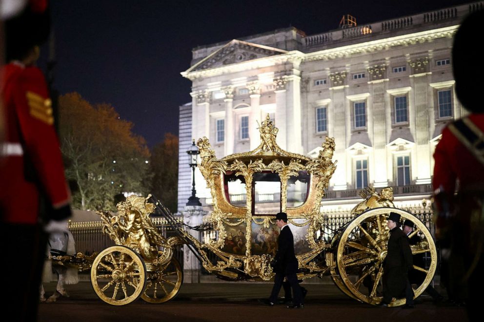 PHOTO: The Gold State Coach is driven alongside members of the military during a full overnight dress rehearsal of the coronation procession for Britain's King Charles and Camilla, Queen Consort, in London, May 3, 2023.