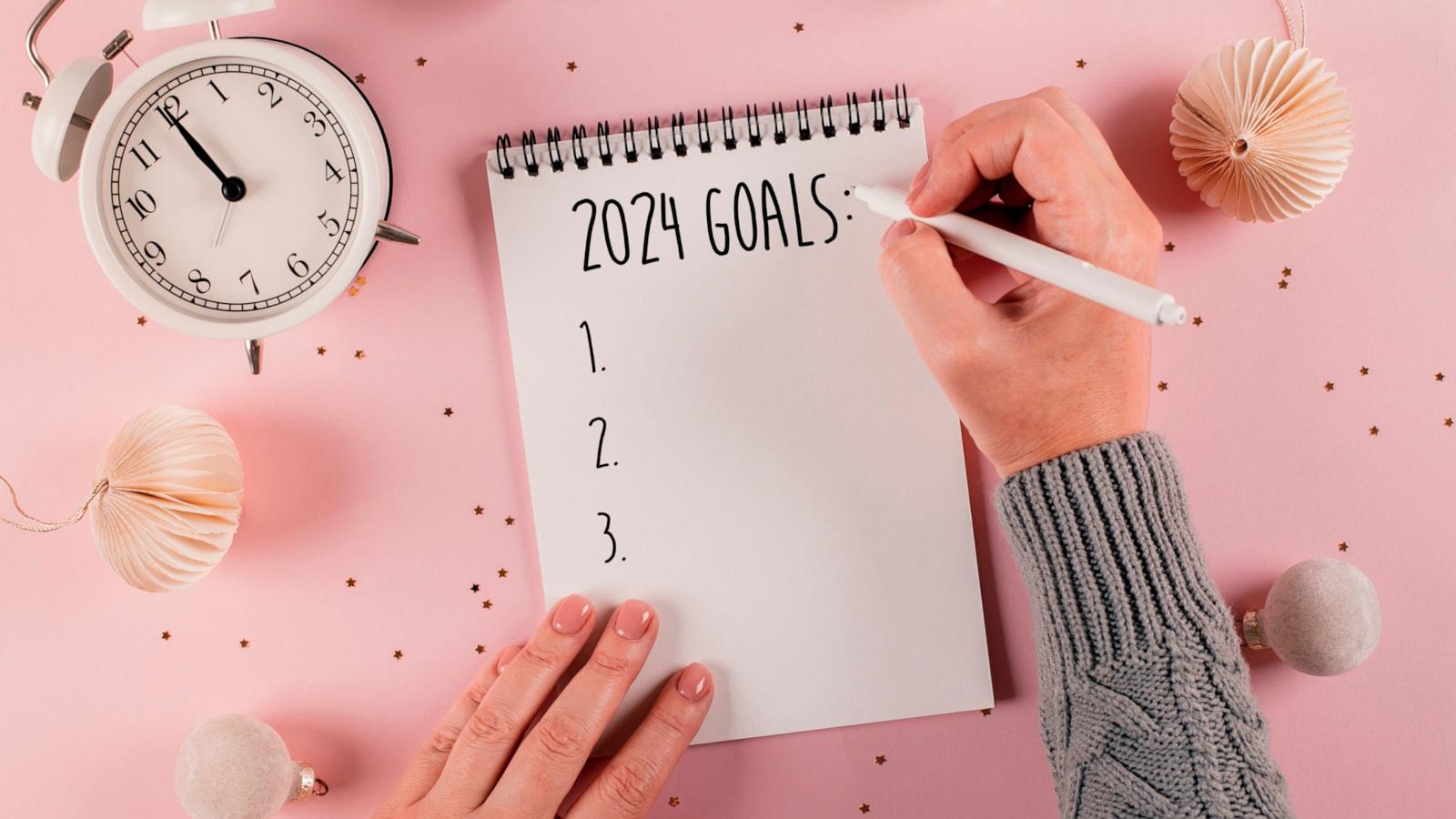 PHOTO: In this undated stock photo, a woman's hand is seen writing goals for 2024.