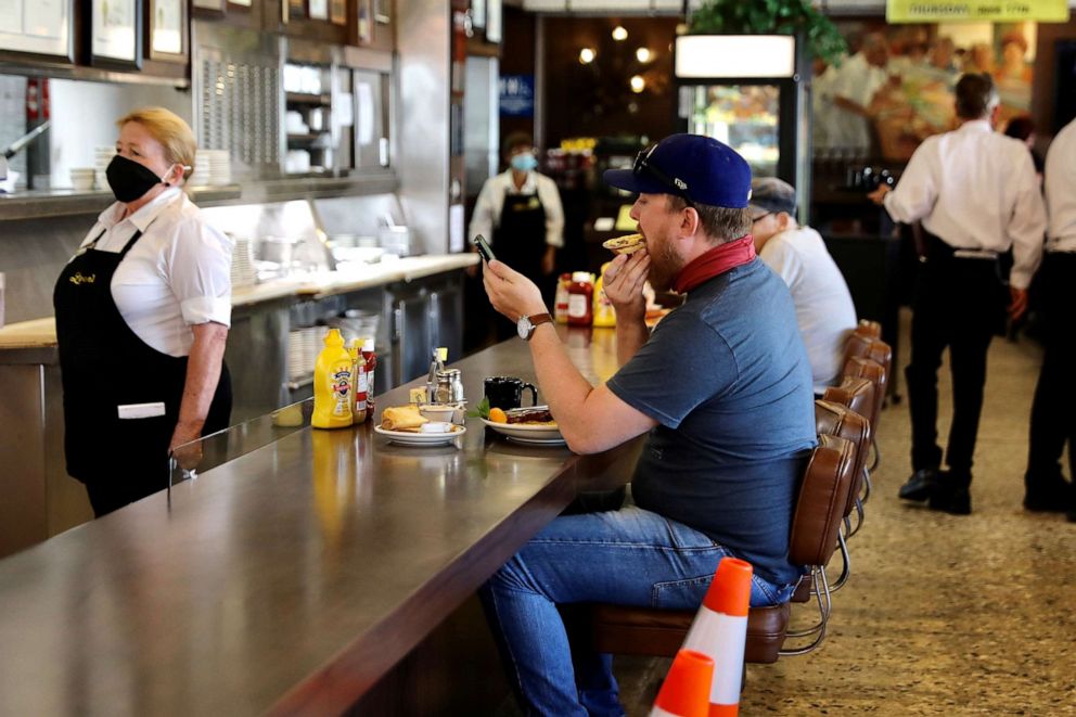 PHOTO: Customers enjoy their breakfast at the Langer's Delicatessen-Restaurant in Westlake, Los Angeles, June 15, 2021.