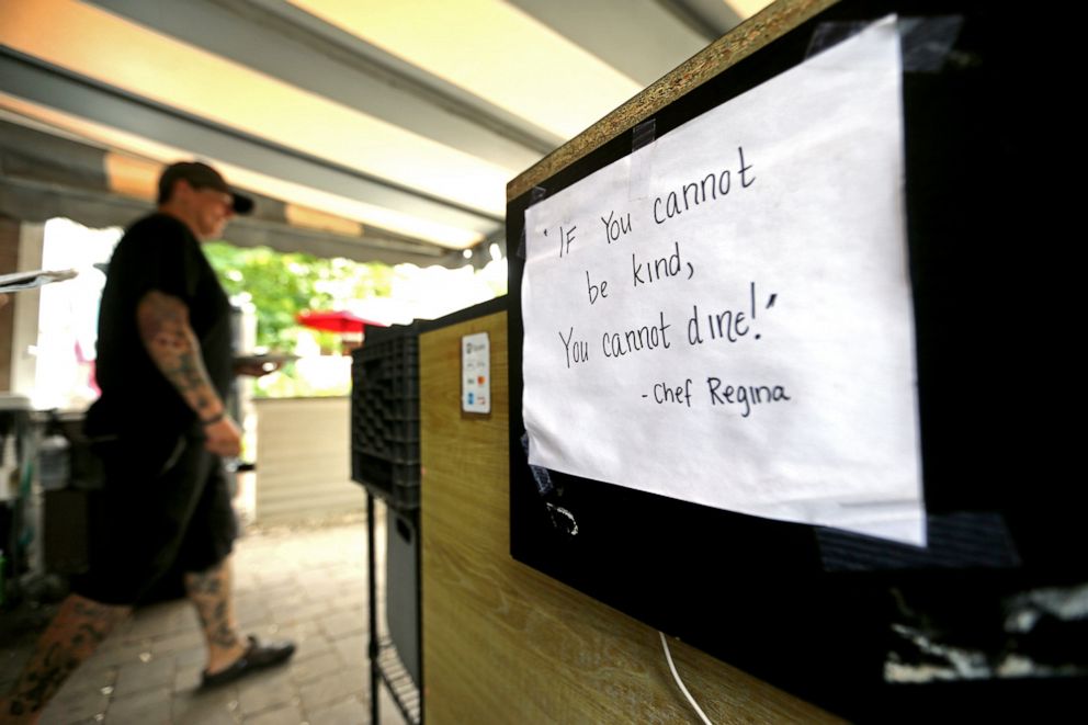 PHOTO: A sign reading, "If you cannot be kind, you cannot dine," is posted near the entrance of Apt Cape Cod restaurant in Brewster, Mass., July 14, 2021.