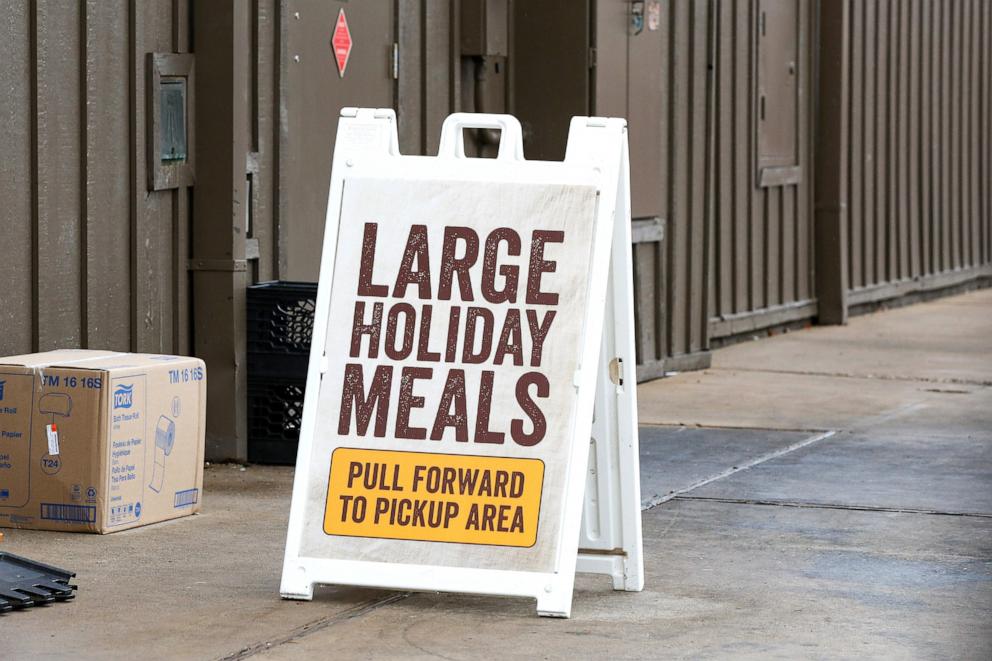 PHOTO: In this Nov. 22, 2023, file photo, a sign at a Cracker Barrel restaurant directs customers to the area to pick up take-home Thanksgiving family meals. 