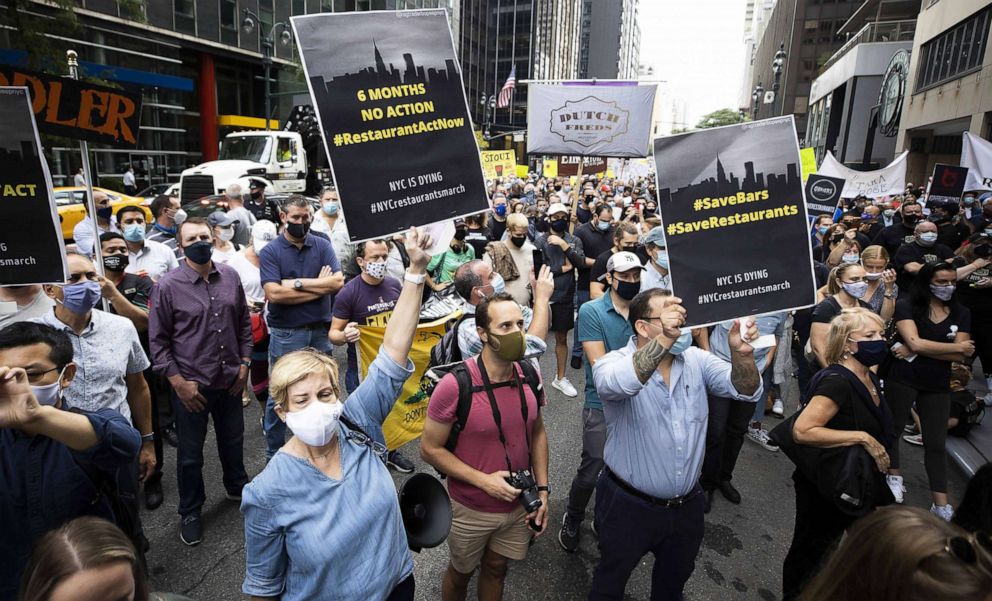 PHOTO: People gather for a protest outside of the offices of New York Governor Andrew Cuomo calling for a loosing of occupancy restrictions for the city's restaurants in New York, Sept. 28, 2020.