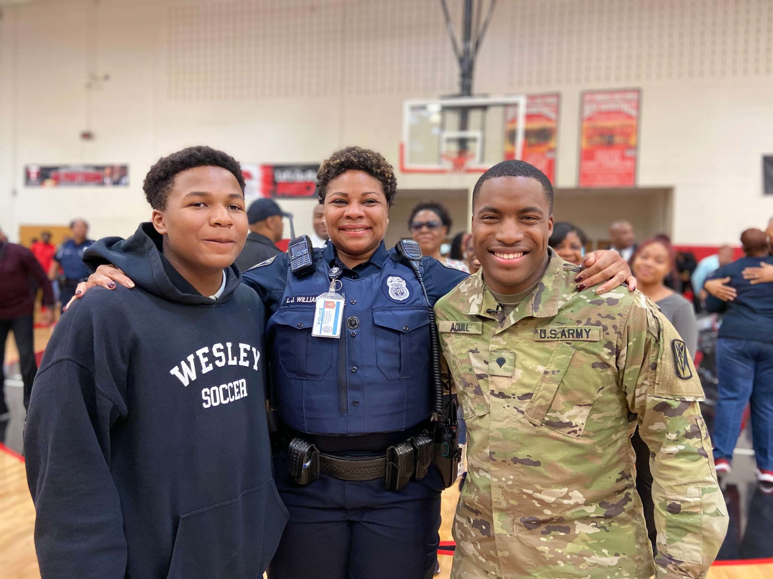 PHOTO: Officer Williamson, center, poses with her sons Justin Patillo, left, and Shakir Aquil