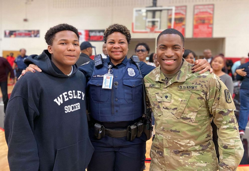 PHOTO: Officer Williamson, center, poses with her sons Justin Patillo, left, and Shakir Aquil