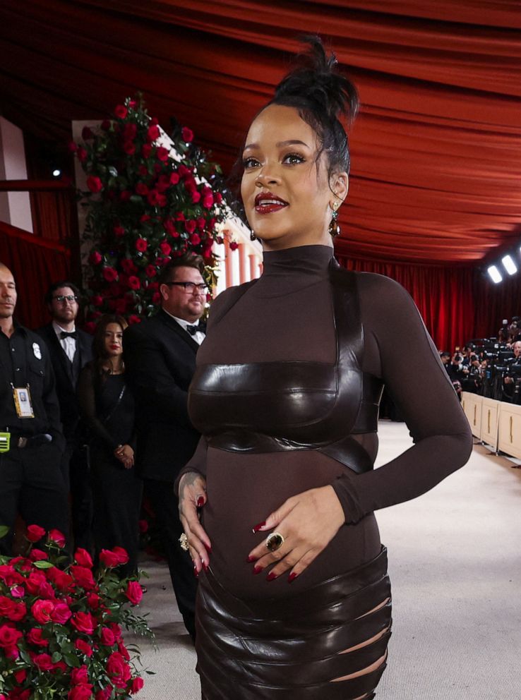 PHOTO: Rihanna poses on the champagne-colored red carpet during the Oscars arrivals at the 95th Academy Awards in Hollywood.