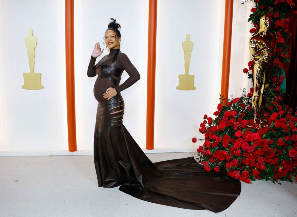 PHOTO: Rihanna poses on the champagne-colored red carpet during the Oscars arrivals at the 95th Academy Awards in Hollywood, March 12, 2023.