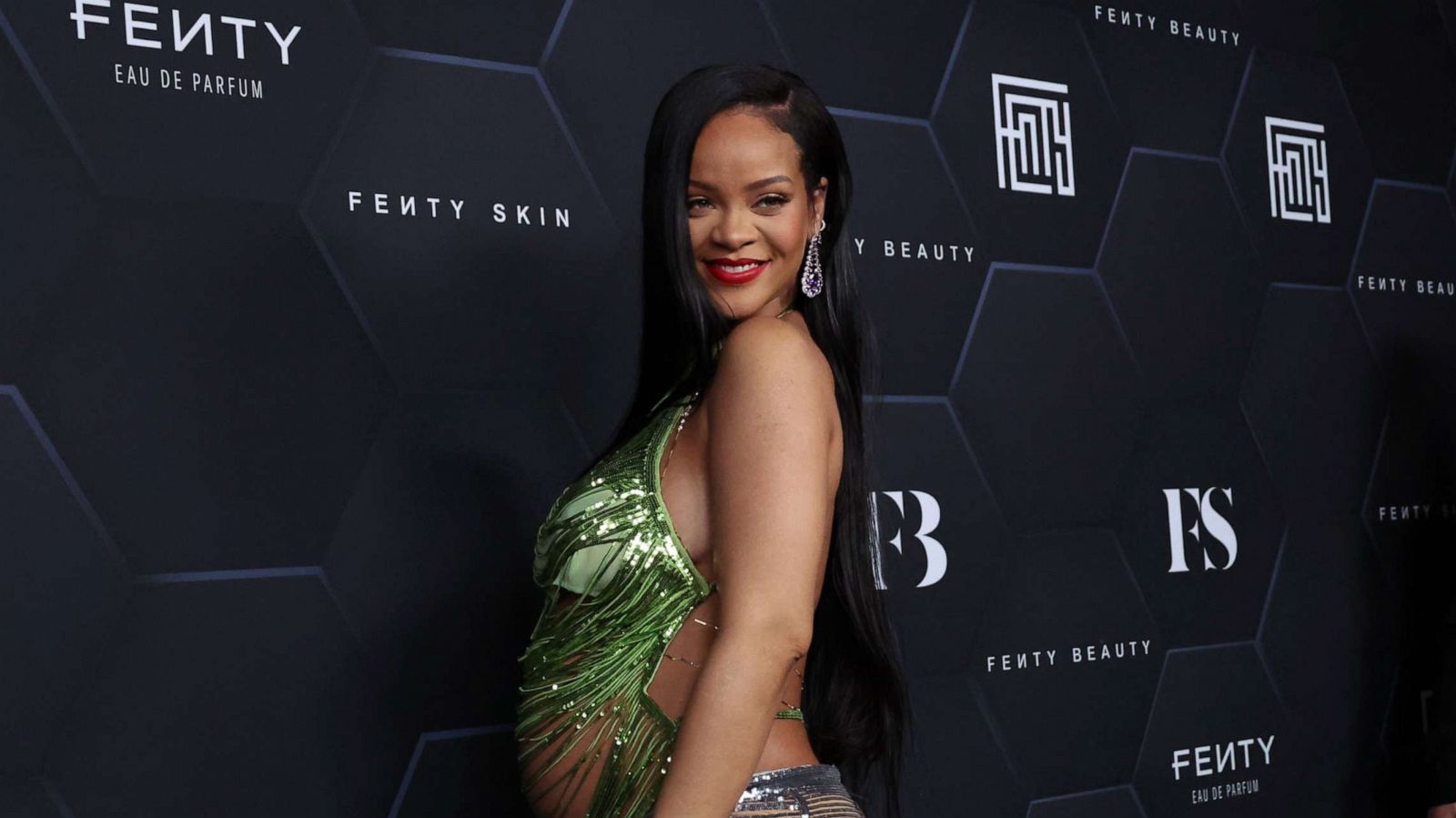 PHOTO: Rihanna poses for a picture as she celebrates her beauty brands Fenty Beauty and Fenty Akin at Goya Studios on Feb. 11, 2022, in Los Angeles, Calif.