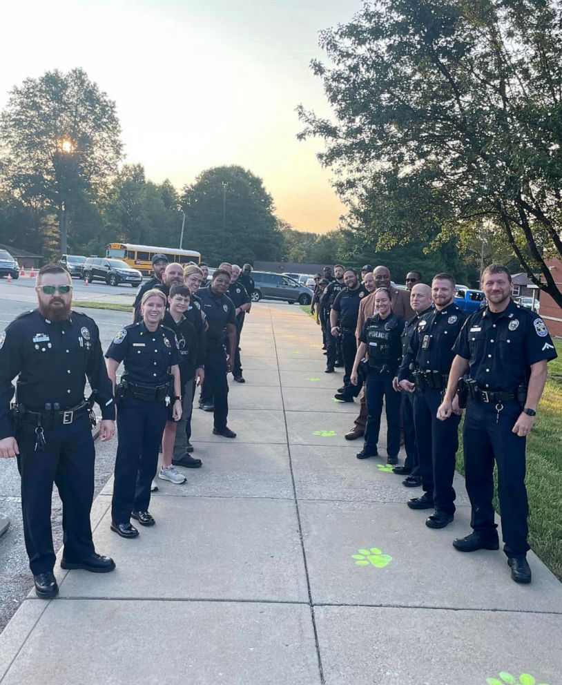 PHOTO: Louisville Metro Police Department officers lined the sidewalk Tuesday to welcome Riley Cottongim, the son of a fallen police officer, on his first day of kindergarten.