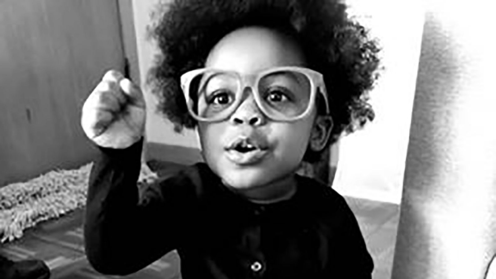 PHOTO: Riley Johnson, 2, poses in costume as author and activist Angela Davis.