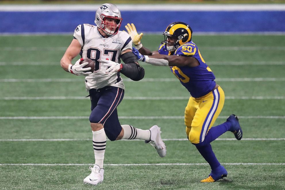 PHOTO: Rob Gronkowski of the New England Patriots runs the ball against Samson Ebukam #50 of the Los Angeles Rams in the second half during Super Bowl LIII at Mercedes-Benz Stadium, Feb. 3, 2019 in Atlanta.