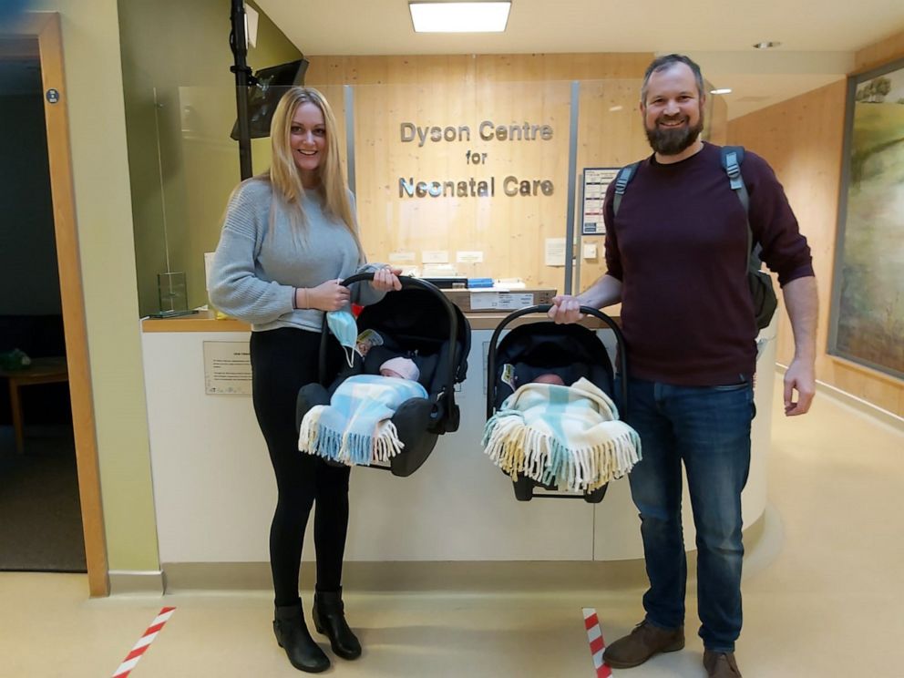 PHOTO: Rebecca Roberts and Rhys Weaver pose with their twin newborns, Noah and Rosalie.