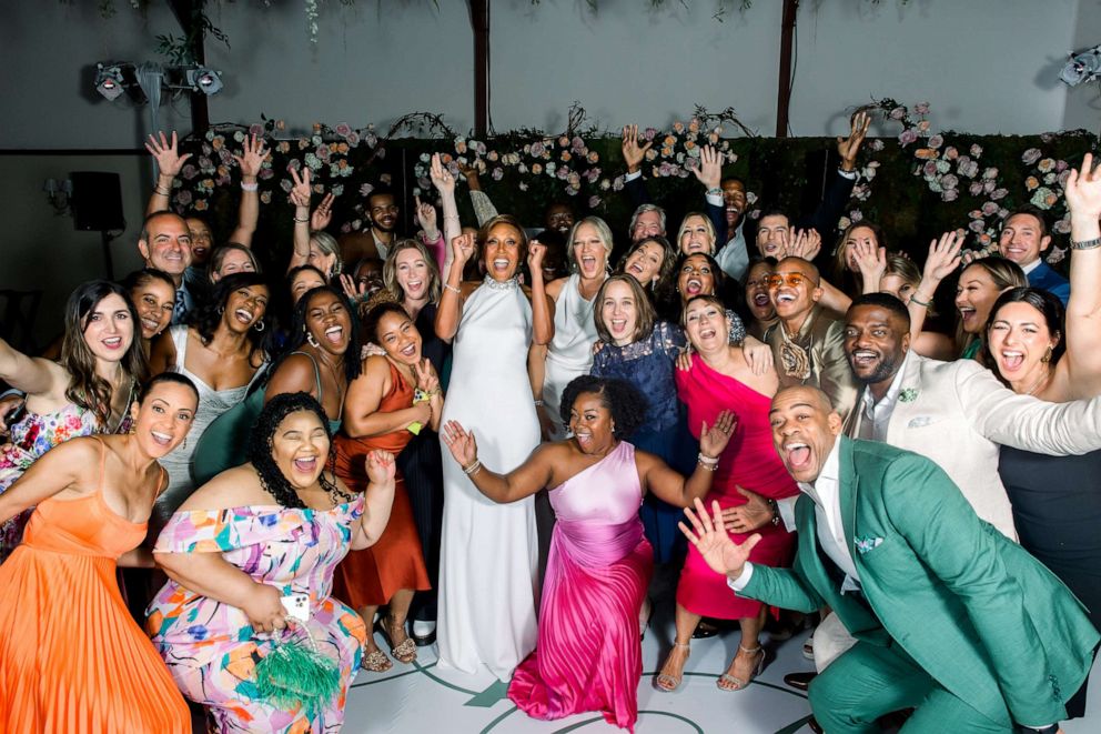 PHOTO: Robin Roberts and Amber Laign are surrounded by the production teams from “Good Morning America” and ABC News at their wedding celebration.