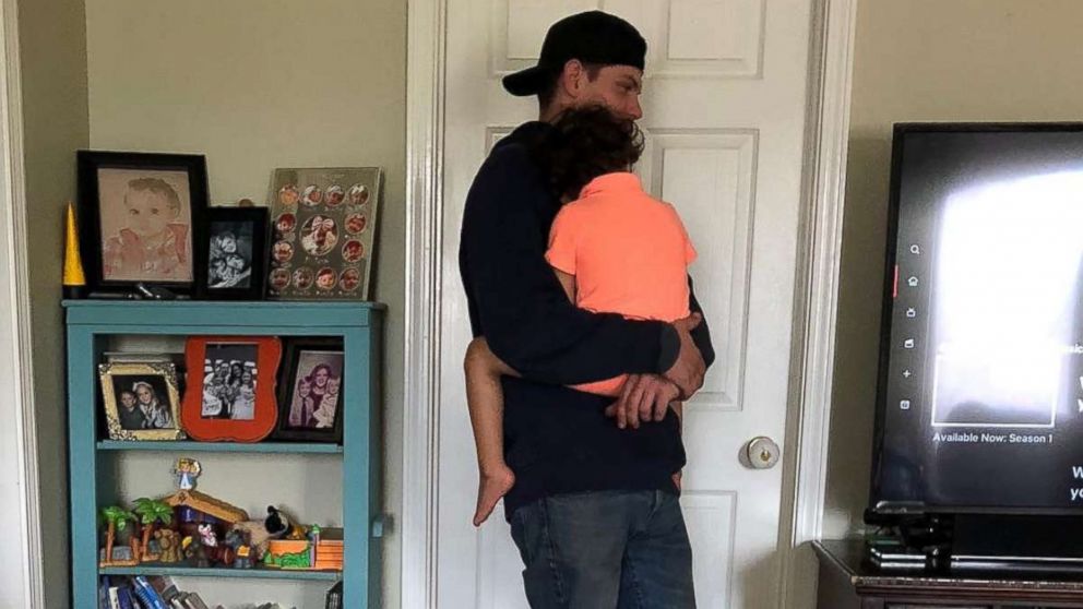 Rob Kinney, a technician with Spectrum, came to Jessica Nash Donnahoo's home to set up TV streaming and held her 3-year-old son Sailor while he worked.