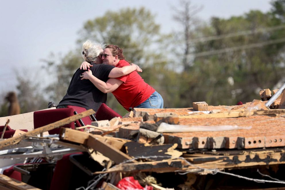 PHOTO: Women hug among the rubble of a home as cleanup continues in the aftermath of a tornado four days before, Mar. 28, 2023, in Rolling Fork, Miss.