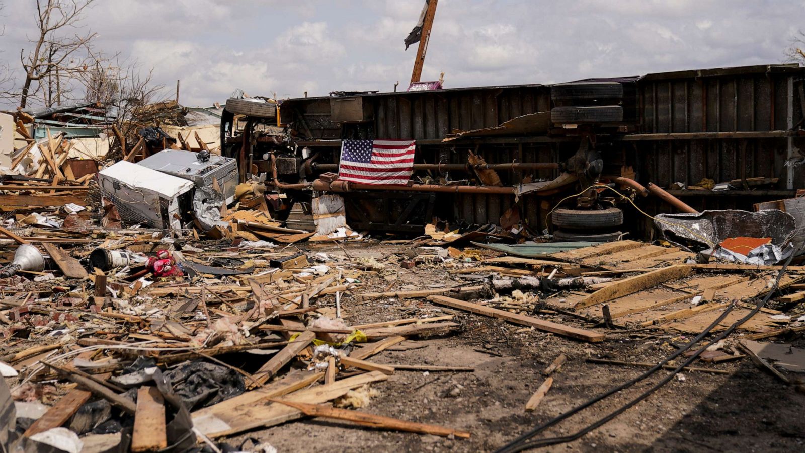 PHOTO: An American flag is seen on an overturned vehicle in Rolling Fork, Miss., March 31, 2023, after a deadly tornado and severe storm moved through the area.