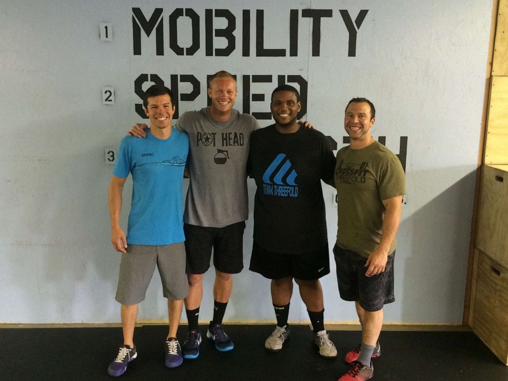 PHOTO: Romar Lyle poses with his coaches who help him continue to live a healthy lifestyle.