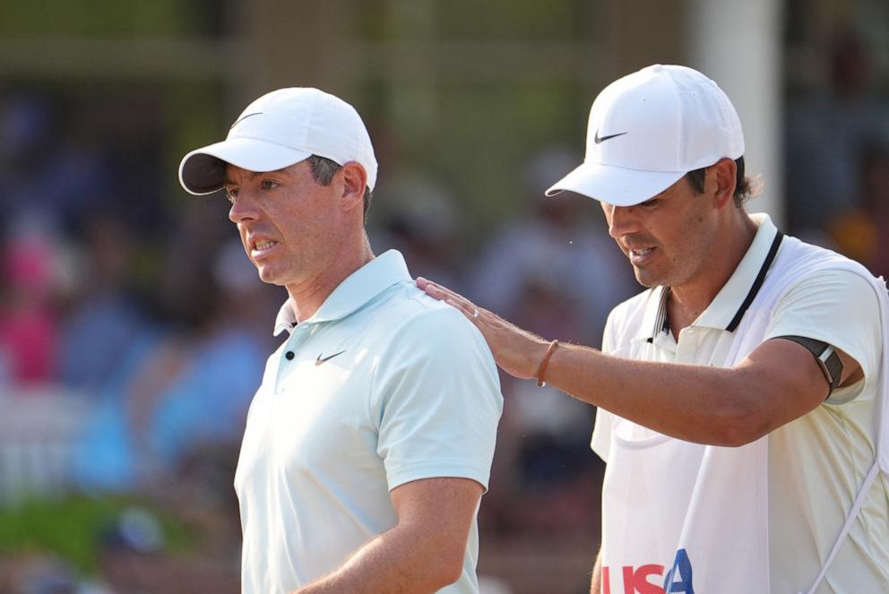 PHOTO: Rory McIlroy reacts after a missed putt on the eighteenth green with his caddie, Harry Diamond during the final round of the U.S. Open golf tournament, Jun 16, 2024, in Pinehurst, North Carolina.