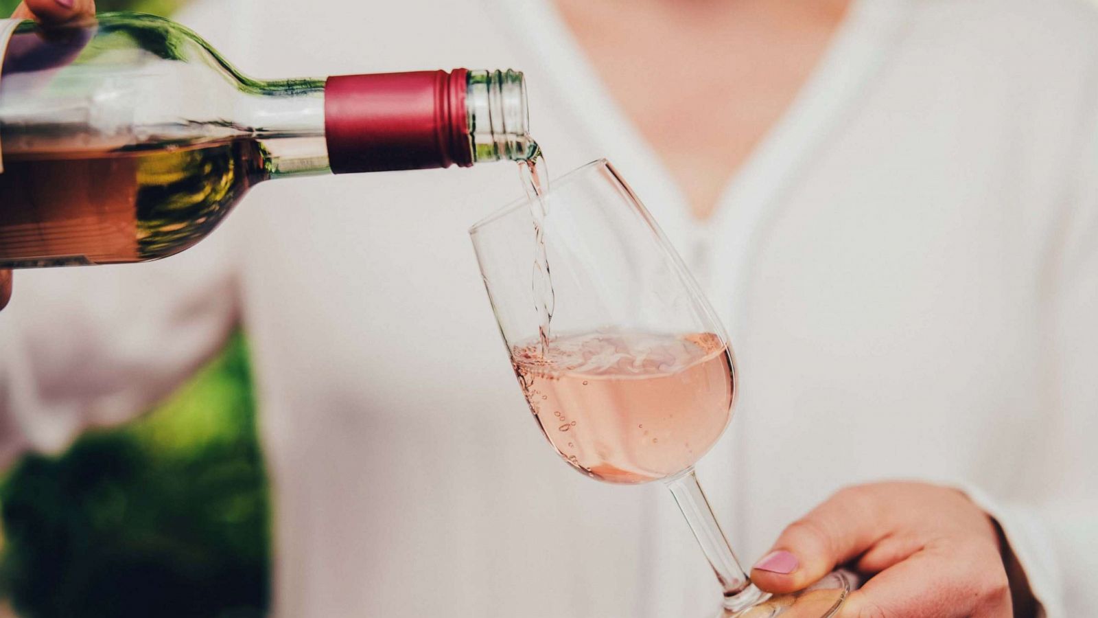 PHOTO: Woman pouring wine in glass.