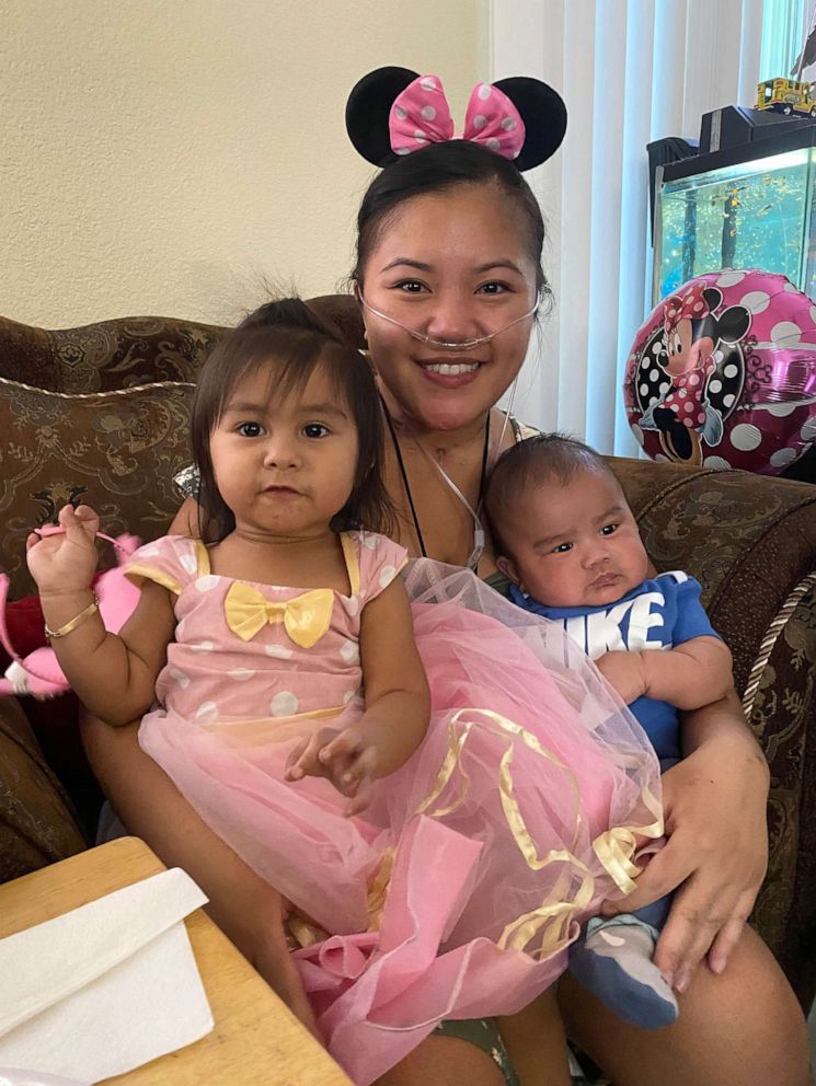 PHOTO: Rowena Salas, 32, poses with her daughter Mia and son Oliver at home after spending several months hospitalized due to COVID-19 complications.