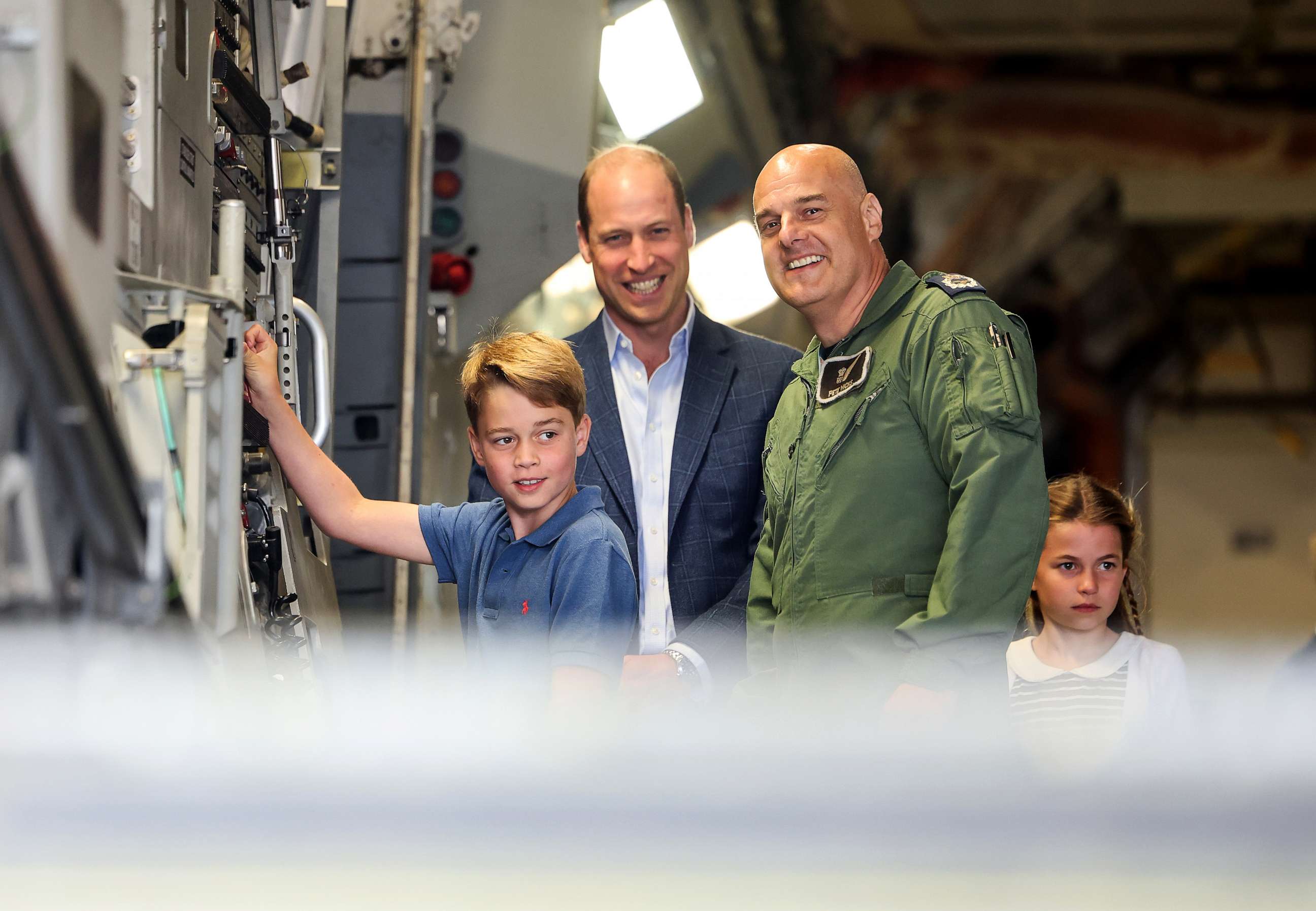 PHOTO: Prince George of Wales raises the ramp on the C17 plane during the visit to the Air Tattoo at RAF Fairford with Prince William, Prince of Wales and Princess Charlotte of Wales on July 14, 2023 in Fairford, England.