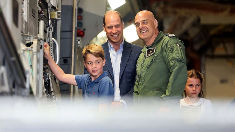 PHOTO: Prince George of Wales raises the ramp on the C17 plane during the visit to the Air Tattoo at RAF Fairford with Prince William, Prince of Wales and Princess Charlotte of Wales on July 14, 2023 in Fairford, England.