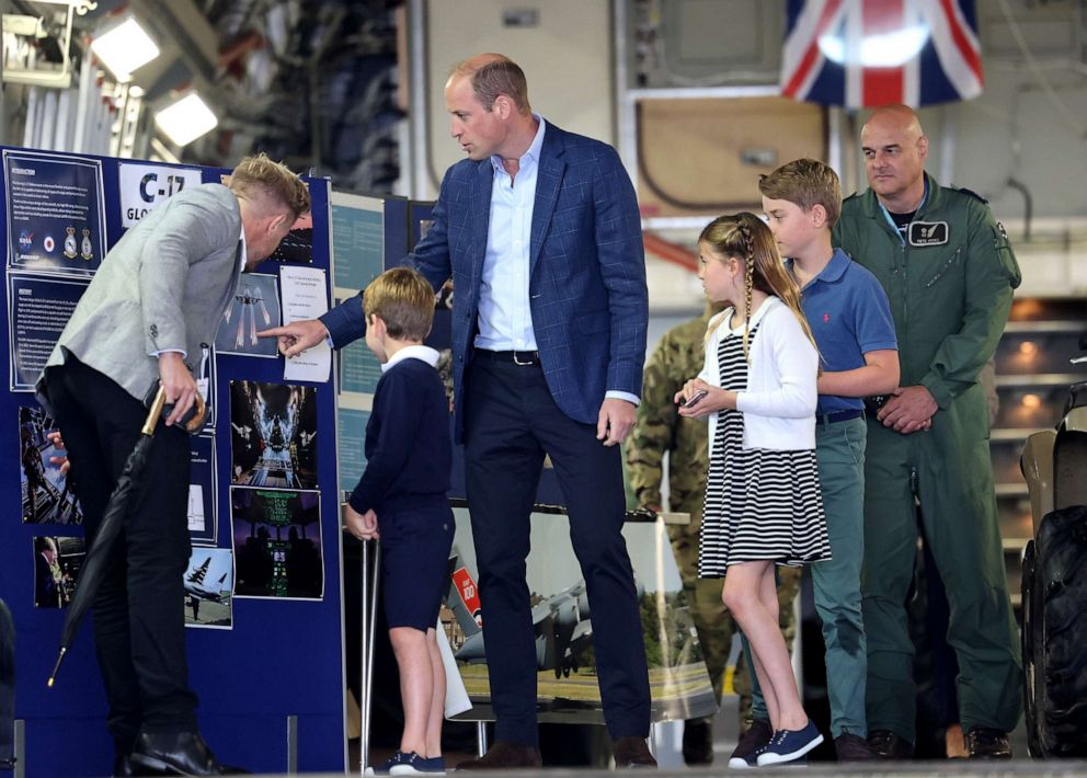 PHOTO: Prince William with Prince George, Princess Charlotte and Prince Louis as they read information on a board inside a C17 plane during their visit to the Air Tattoo at RAF Fairford, July 14, 2023 in Fairford, England.