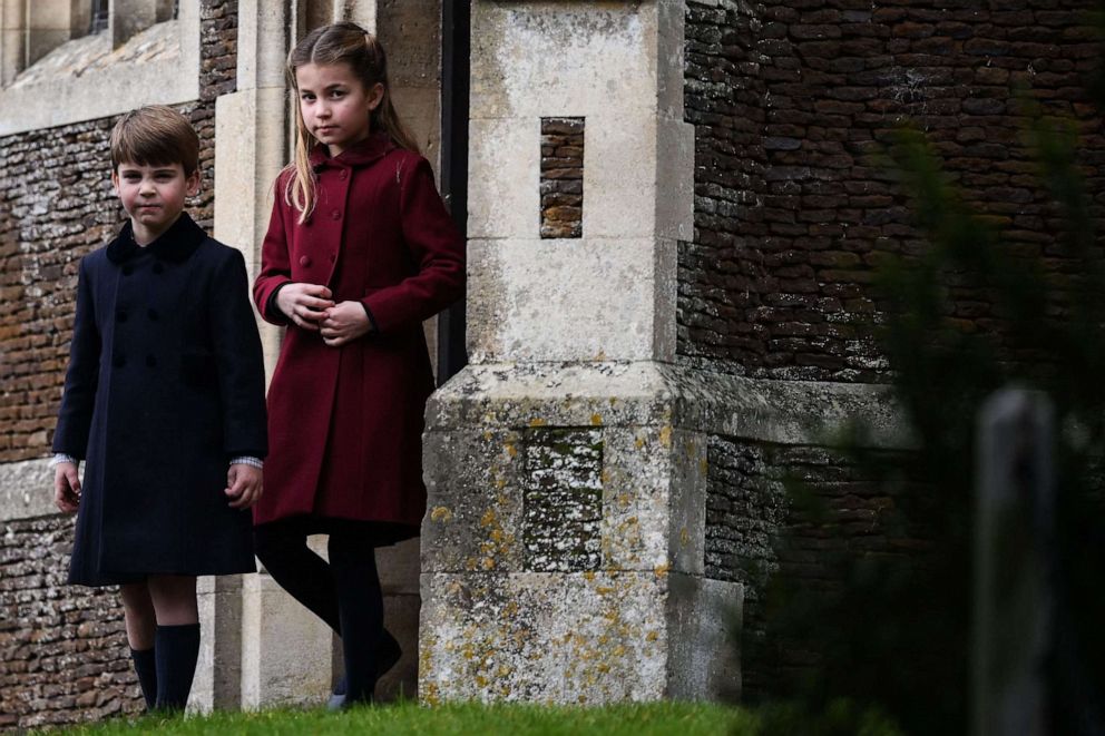 PHOTO: Britain's Prince Louis of Wales and Princess Charlotte of Wales react as they leave at the end of the Royal Family's traditional Christmas Day service at St Mary Magdalene Church, December 25, 2022.