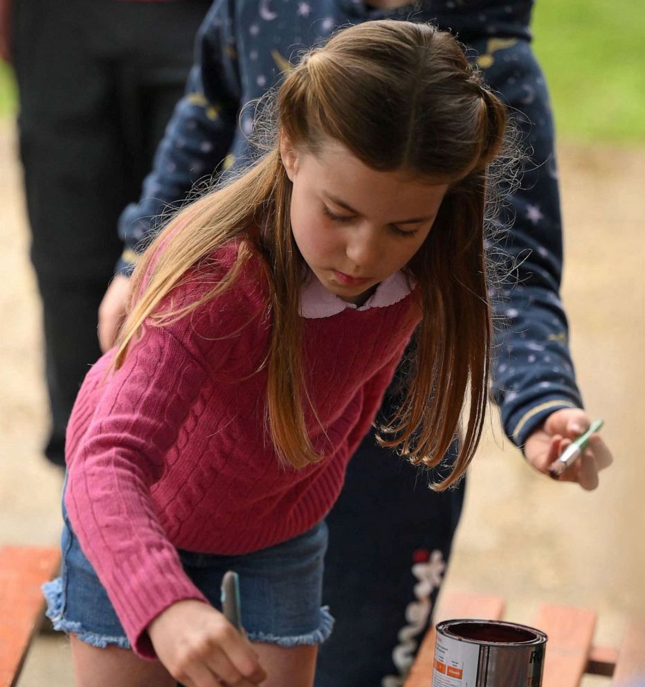 PHOTO: Princess Charlotte of Wales paints some wood while taking part in the Big Help Out, during a visit to the 3rd Upton Scouts Hut in Slough, west of London on May 8, 2023.