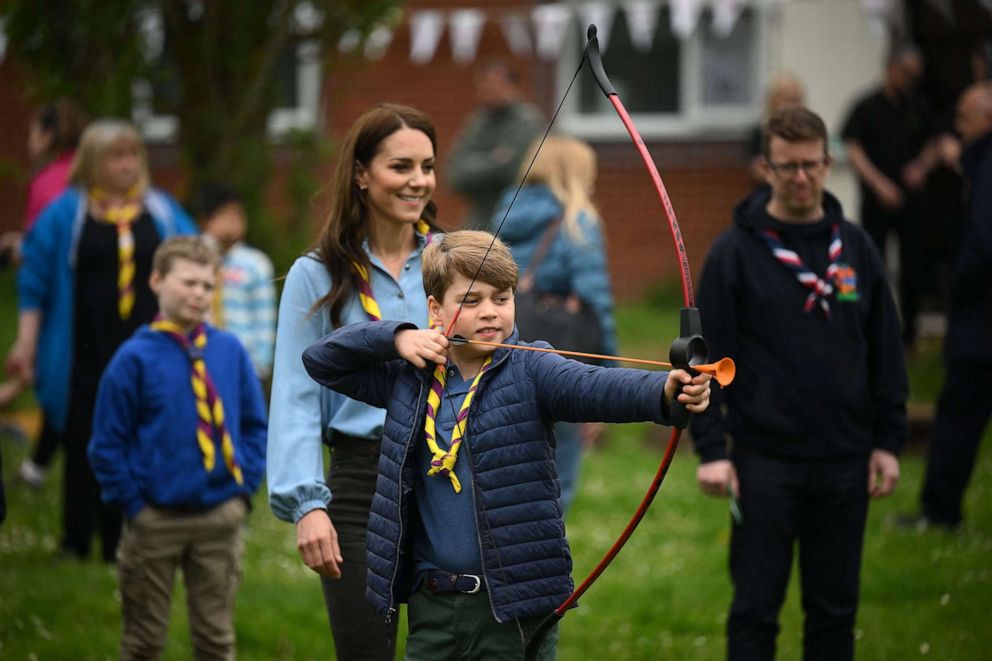 PHOTO: Watched by his mother Britain's Catherine, Princess of Wales, Britain's Prince George of Wales tries his hand at archery while taking part in the Big Help Out, during a visit to the 3rd Upton Scouts Hut in Slough, west of London on May 8, 2023