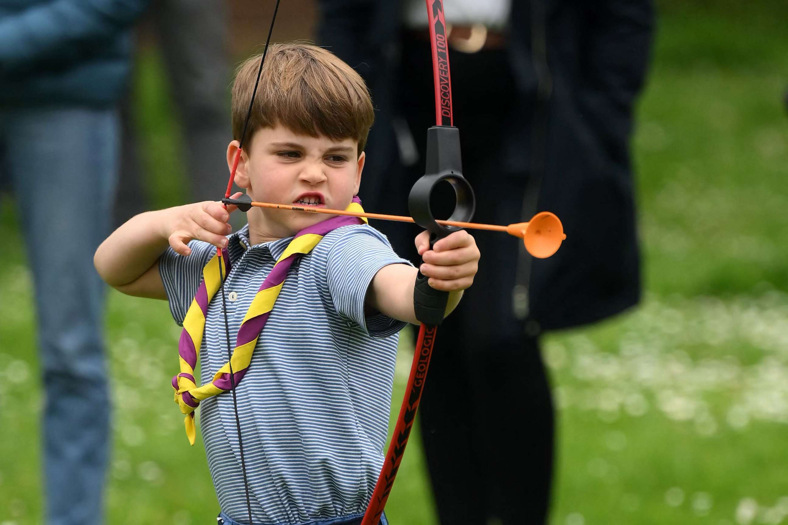 PHOTO: Prince Louis of Wales tries his hand at archery while taking part in the Big Help Out, during a visit to the 3rd Upton Scouts Hut in Slough, west of London on May 8, 2023.