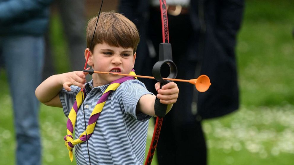 PHOTO: Prince Louis of Wales tries his hand at archery while taking part in the Big Help Out, during a visit to the 3rd Upton Scouts Hut in Slough, west of London on May 8, 2023.