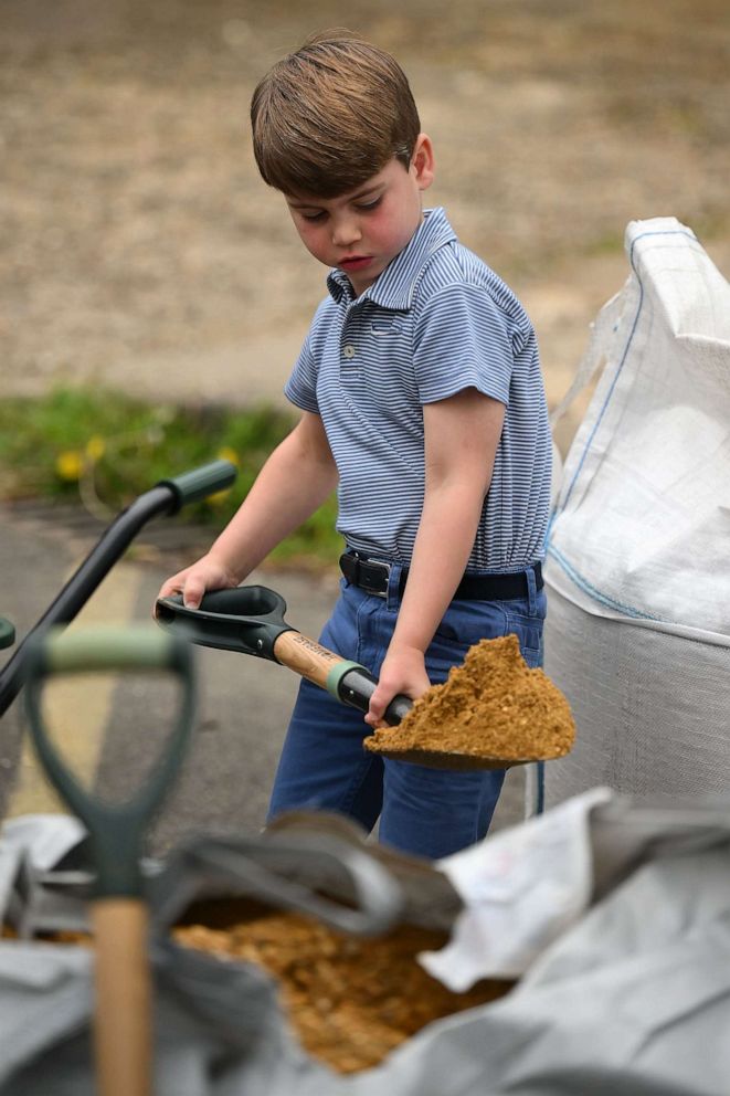 PHOTO: Prince Louis of Wales helps take part in the Big Help Out, during a visit to the 3rd Upton Scouts Hut in Slough on May 8, 2023 in London.