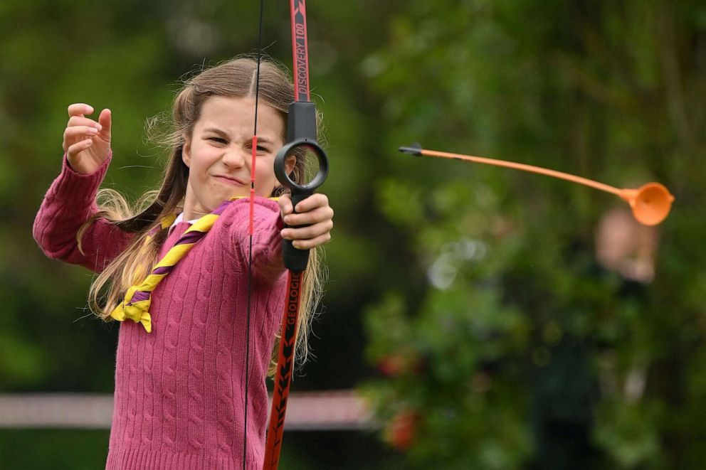 PHOTO: Princess Charlotte of Wales tries her hand at archery while taking part in the Big Help Out, during a visit to the 3rd Upton Scouts Hut in Slough, west of London, May 8, 2023.