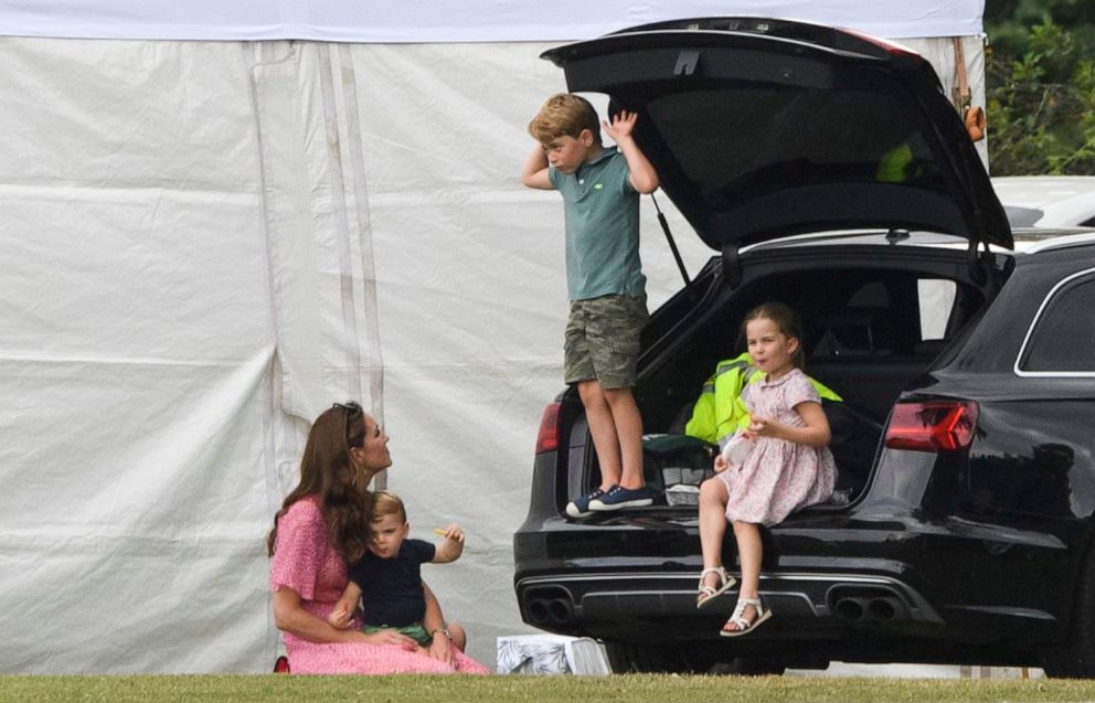 PHOTO: Catherine Duchess of Cambridge sits with the royal children, Prince Louis, Princess Charlotte and Prince George at the King Power Royal Charity Polo Day in Wokingham, UK on July 10, 2019.
