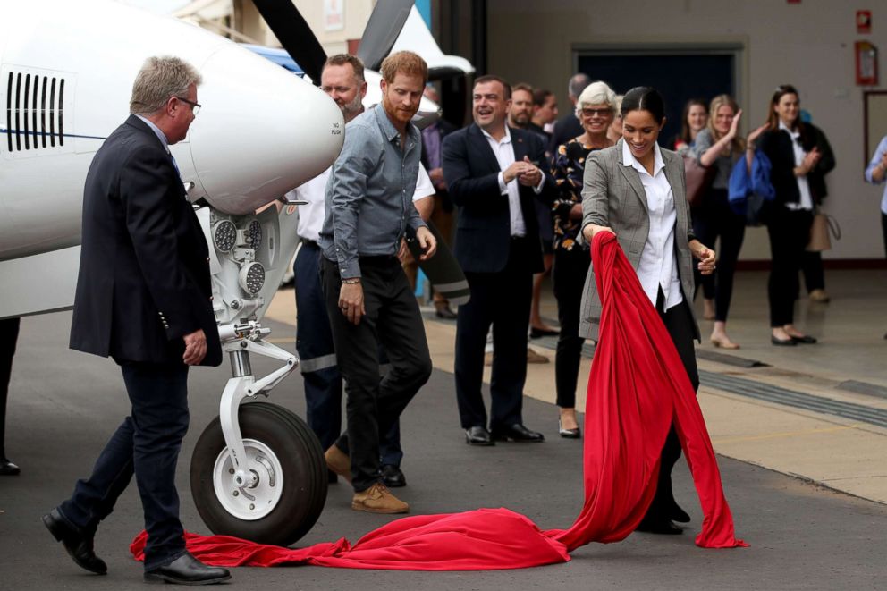 PHOTO: Prince Harry, Duke of Sussex and Meghan, Duchess of Sussex unveil a new aircraft in the Royal Flying Doctor Service as they visit the Royal Flying Doctors Service hangar, Oct. 17, 2018, in Dubbo, Australia.