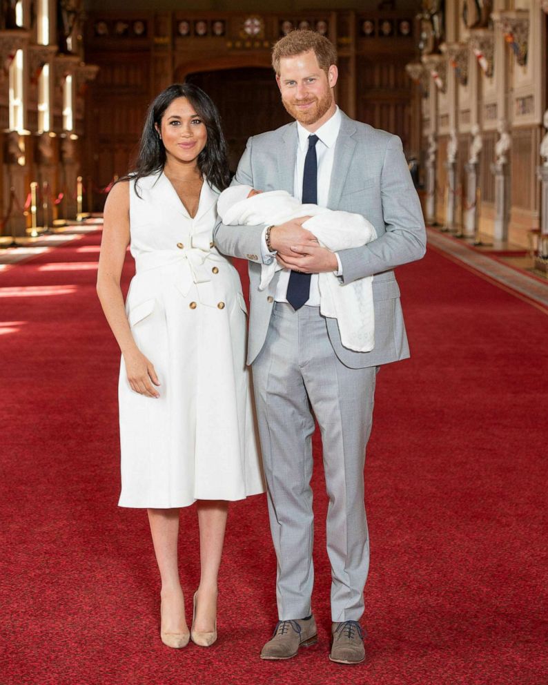 PHOTO: Prince Harry and Meghan, Duchess of Sussex, during a photocall with their newborn son, in St George's Hall at Windsor Castle in England, May 8, 2019. Prince William and Catherine, Duchess of Cambridge, walk along Newborough Beach in north Wales.