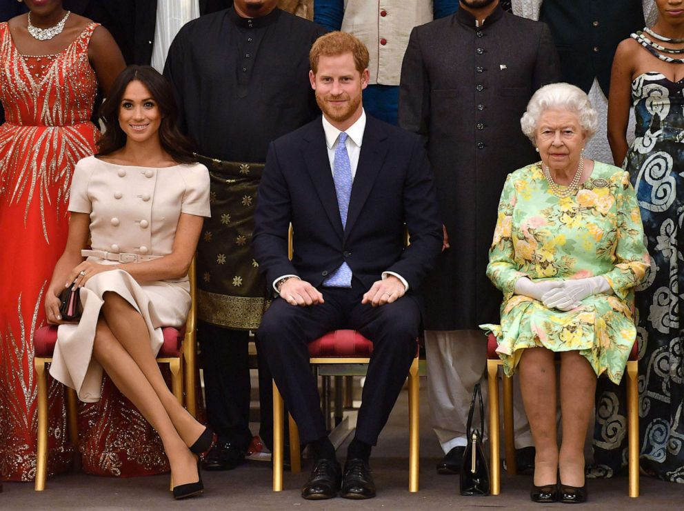PHOTO: Meghan, Duchess of Sussex, Britain's Prince Harry, Duke of Sussex and Britain's Queen Elizabeth II pose for a picture during the Queen's Young Leaders Awards Ceremony on June 26, 2018 at Buckingham Palace in London. 