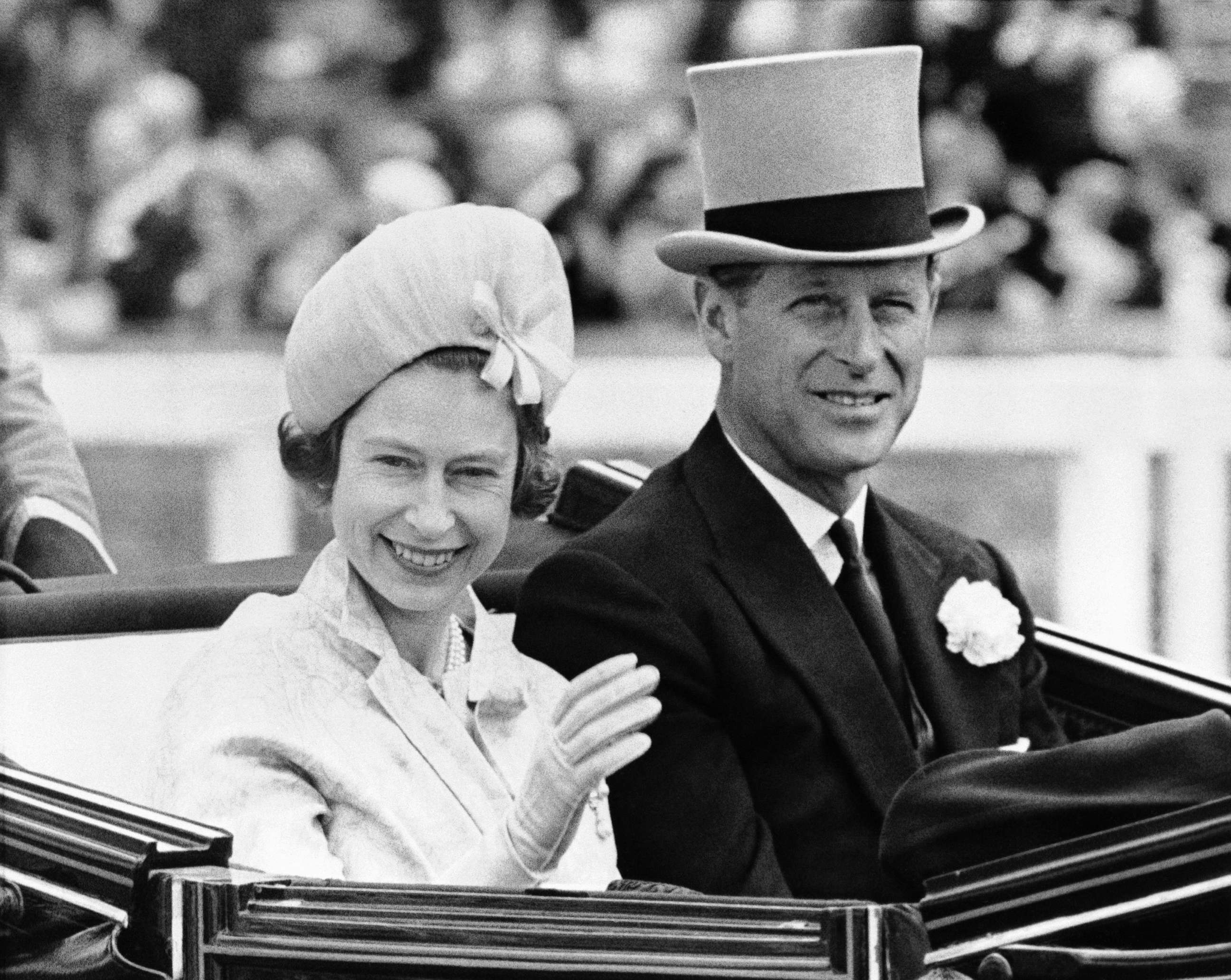 PHOTO: In this June 19, 1962 file photo, Britain's Queen Elizabeth II and Prince Philip travel by open carriage around the track prior to the race program, in Ascot, England.