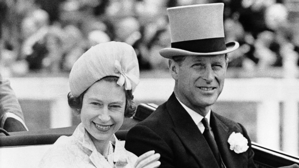 PHOTO: In this June 19, 1962 file photo, Britain's Queen Elizabeth II and Prince Philip travel by open carriage around the track prior to the race program, in Ascot, England.