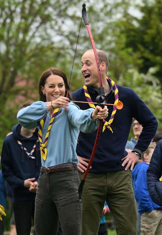 PHOTO: Catherine, Princess of Wales, tries her hand at archery as Prince William, Prince of Wales, reacts while taking part in the Big Help Out, during a visit to the 3rd Upton Scouts Hut in Slough, west of London, May 8, 2023.