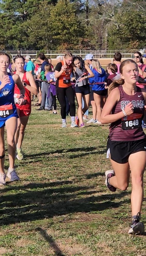 PHOTO: Kaylee Montgomery helped a fellow runner whose legs gave out across the finish line during the last race of her high school career.