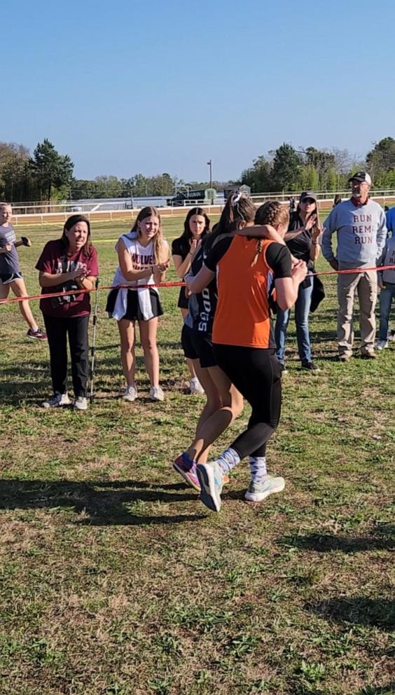 PHOTO: Kaylee Montgomery helped a fellow runner whose legs gave out across the finish line during the last race of her high school career.