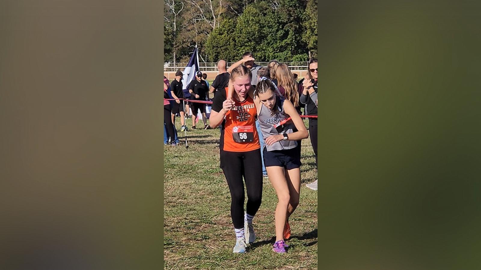 PHOTO: Kaylee Montgomery helped a fellow runner whose legs gave out across the finish line during the last race of her high school career.